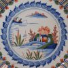London delft charger decorated in in red, blue and green, circa 1700 probably Vauxhall