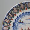 London delft charger decorated in in red, blue and green, circa 1700 probably Vauxhall