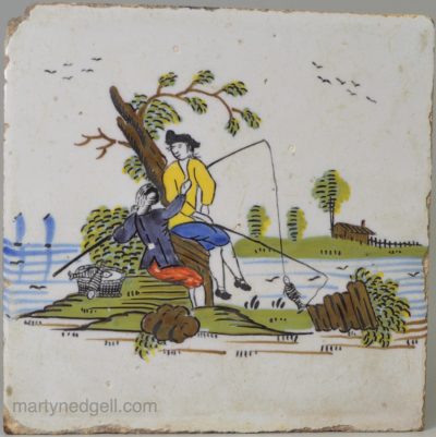 rare Liverpool delft tile decorated in colours with two men fishing, circa 1760