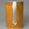 Creamware pottery mug decorated with pumpkin slip and brown inlayed, circa 1810