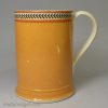 Creamware pottery mug decorated with pumpkin slip and brown inlayed, circa 1810
