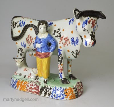 Yorkshire type pearlware pottery cow and attendant group decorated with colours under the glaze, circa 1820