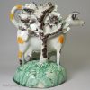 Pearlware pottery cow and calf bocage creamer decorated under the glaze, circa 1800