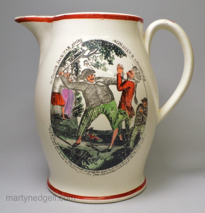 Creamware pottery jug decorated with a print of 'an English JACK-TAR giving MONSIEUR a drubbing', circa 1800