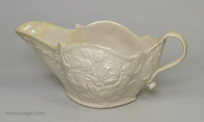 Staffordshire white saltglaze sauceboat moulded with flowers, circa 1760