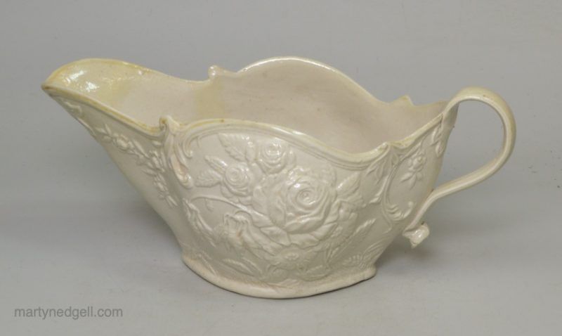 Staffordshire white saltglaze sauceboat moulded with flowers, circa 1760