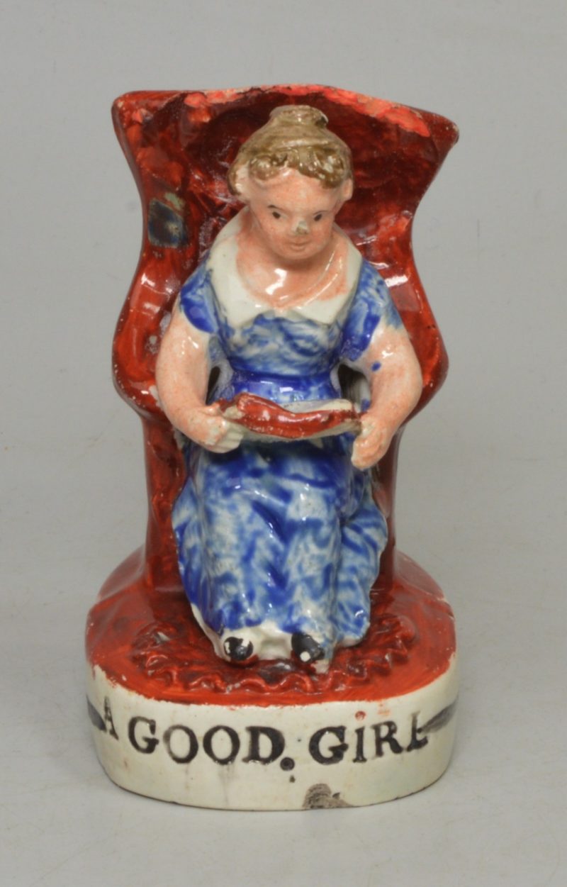 Staffordshire pearlware pottery figure of a girl reading entitled 'A GOOD GIRL', circa 1820
