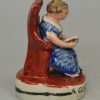 Staffordshire pearlware pottery figure of a girl reading entitled 'A GOOD GIRL', circa 1820
