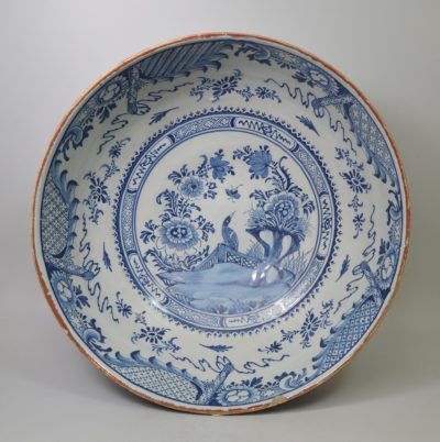 Large diameter Liverpool delft bowl decorated in blue with a bird on a fence, circa 1750