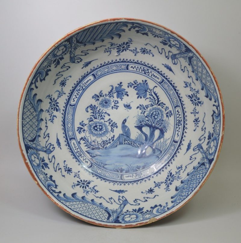 Large diameter Liverpool delft bowl decorated in blue with a bird on a fence, circa 1750