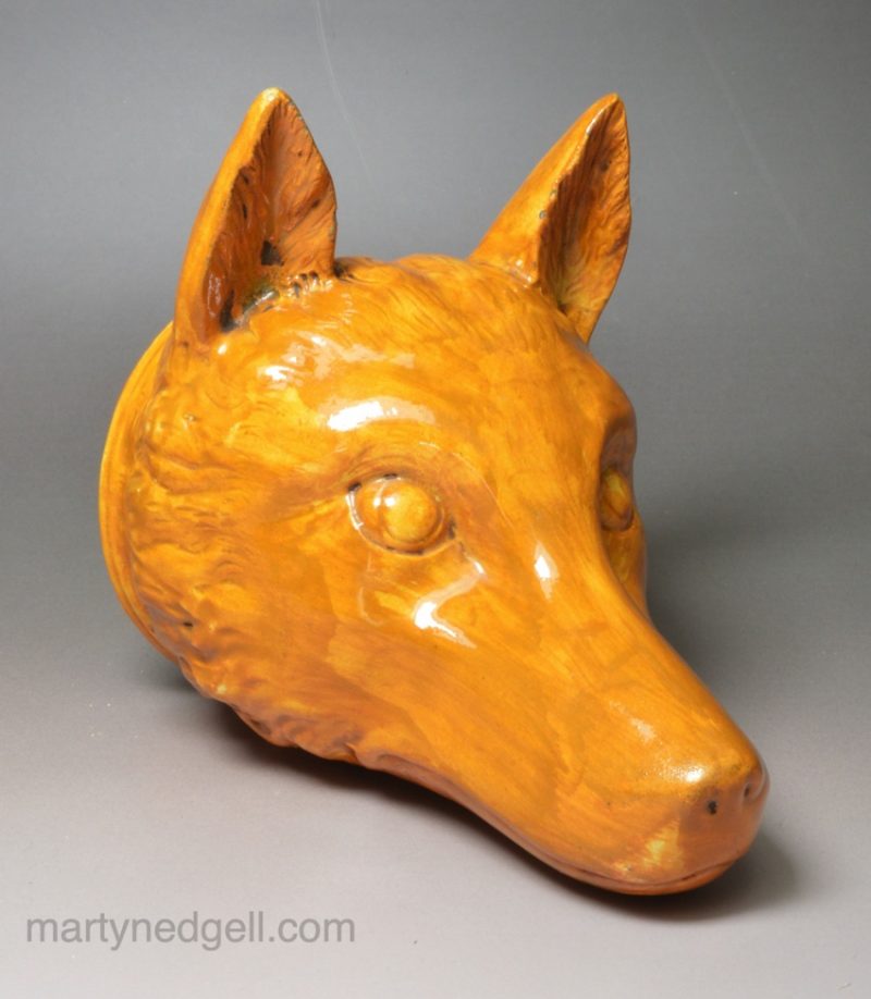 Pearlware pottery stirrup cup decorated with tan oxide under the glaze, circa 1820