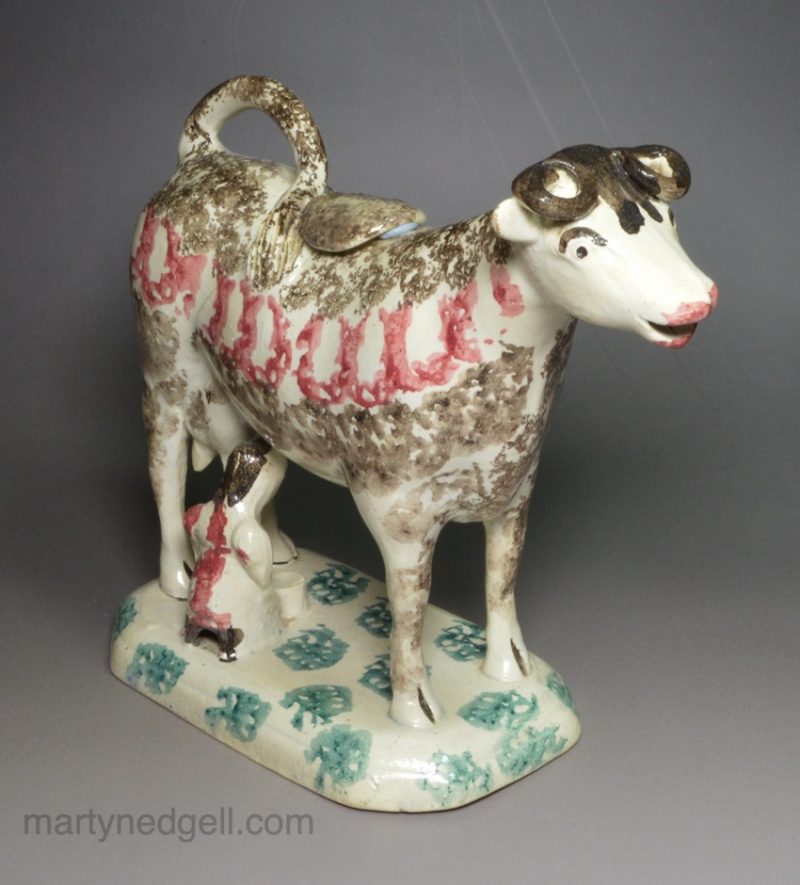 Pearlware pottery cow creamer with sponged decoration, circa 1830
