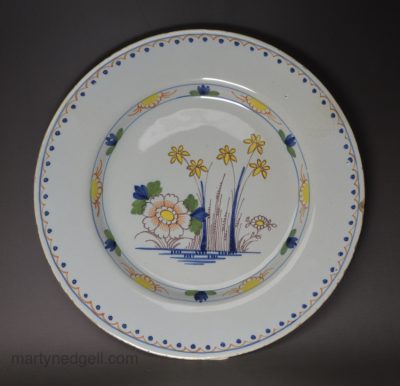 London delft plate decorated in polychrome florals, circa 1750
