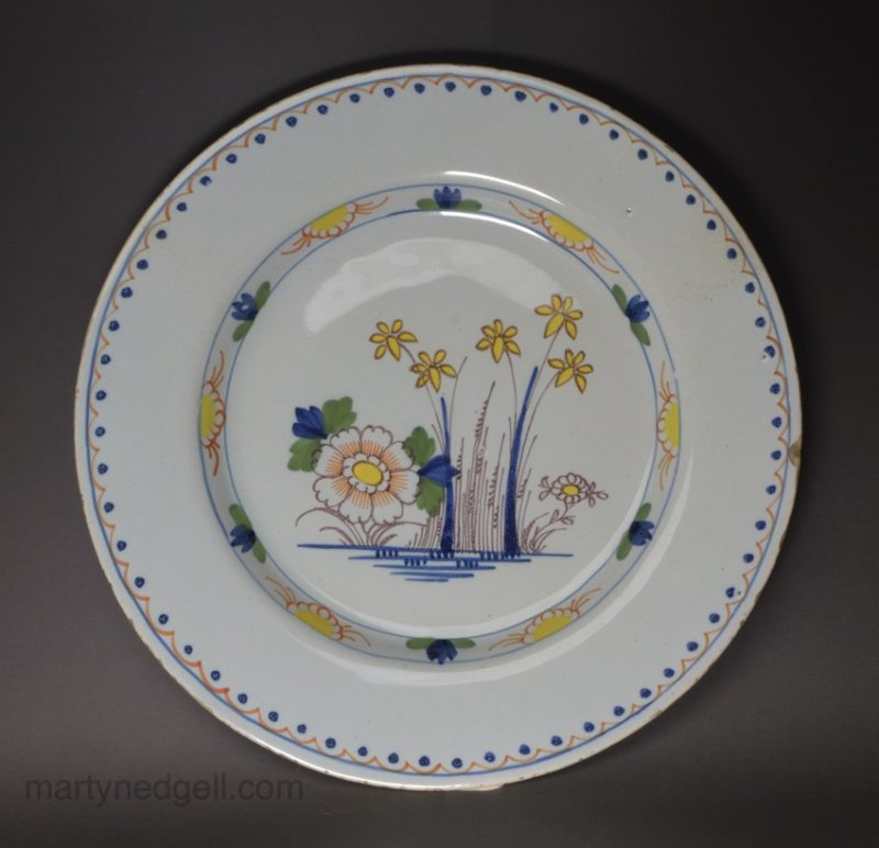 London delft plate decorated in polychrome florals, circa 1750