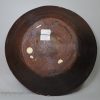 Early Staffordshire slipware dish decorated with a geometric design, circa 1670 - 1700