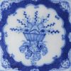 Liverpool delft tile decorated with angel head corners and floral arrangement, circa 1750