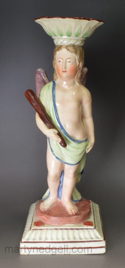 Staffordshire pearlware pottery figural candlestick decorated with overglaze enamels, circa 1820