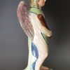 Staffordshire pearlware pottery figural candlestick decorated with overglaze enamels, circa 1820