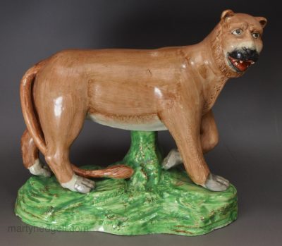 Pearlware pottery lion decorated with enamels over the glaze, circa 1810