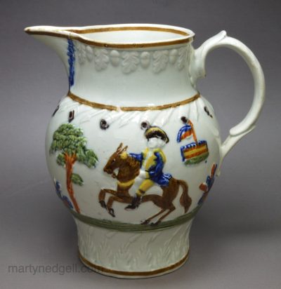 Small prattware pottery moulded jug 'Military Review', circa 1810