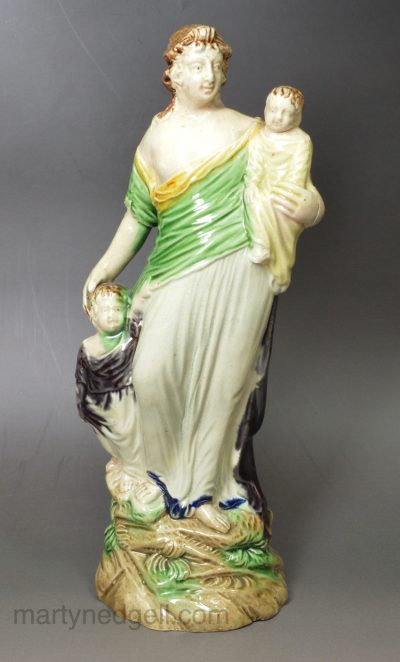 Creamware pottery figure of Charity decorated with colours under the glaze, circa 1795, probably Ralph Wood Pottery Staffordshire