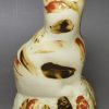 Creamware pottery cat decorated with splashes of slip, circa 1790, probably Bovey Tracey Pottery