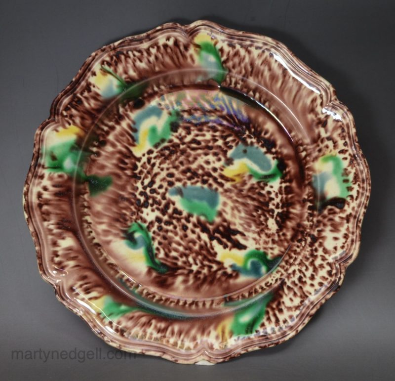 Creamware pottery plate decorated with Whieldon type colours under the glaze, circa 1770
