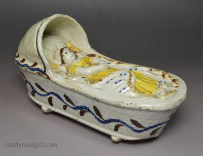 Pearlware pottery toy cradle and baby, circa 1820