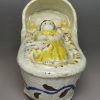Pearlware pottery toy cradle and baby, circa 1820