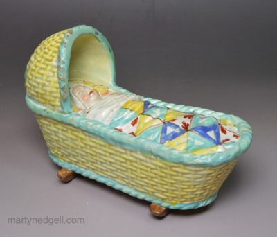 Pearlware pottery child's toy cradle and baby, circa