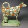 Pearlware pottery cow creamer with sponge decoration, circa 1820