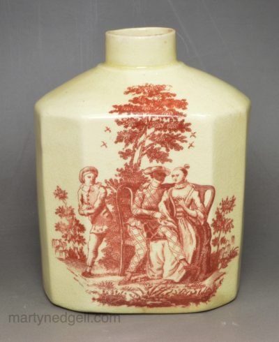 Creamware pottery tea canister decorated with red Sadler type prints, circa 1780