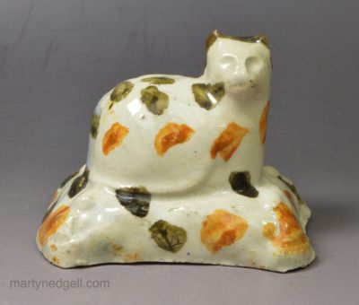 Prattware pottery cat decorated with colours under a pearlware glaze, circa 1800