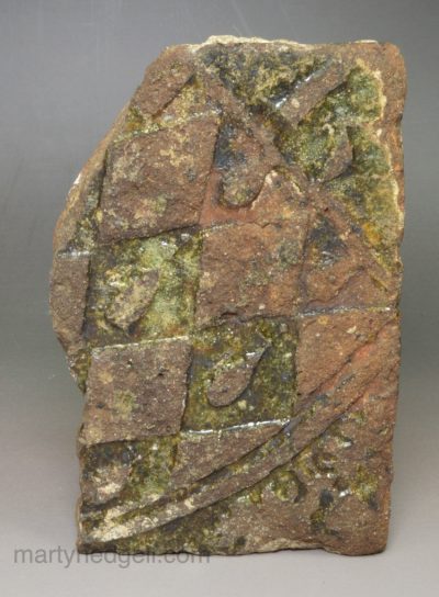 Broken medieval tile of a coat of arms, 14th Century