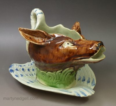 Pearlware pottery swan and fox sauce boat and stand decorated with colours under the glaze, circa 1790