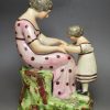 Staffordshire pearlware pottery figure of a mother and daughter, circa 1820