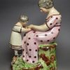 Staffordshire pearlware pottery figure of a mother and daughter, circa 1820