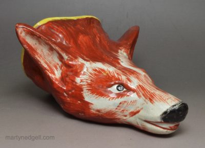 Pearlware pottery fox head stirrup cup decorated with overglaze enamels, circa 1820