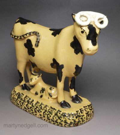 Yorkshire type buff coloured pottery cow and calf, circa 1820