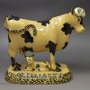 Yorkshire type buff coloured pottery cow and calf, circa 1820