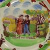 Pearlware pottery child's plate decorated with a print 'GOING TO SCHOOL' and overglaze enamels, circa 1820