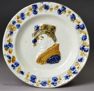 Small commemorative prattware pottery plate moulded with an image of Queen Caroline, circa 1821