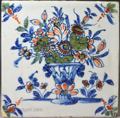 London delft tile decorated with an urn and flowers in blue, red and green, circa 1740