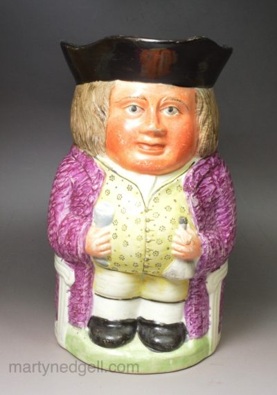 Staffordshire pearlware pottery Toby jug decorated with overglaze enamels, circa 1820
