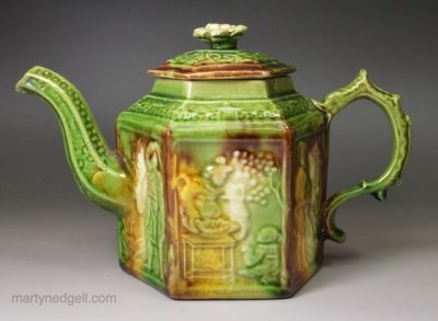 Creamware pottery teapot moulded with Chinoiserie panels and coloured under the glaze, circa 1770