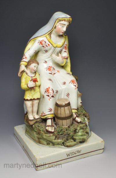 Large Staffordshire pearlware pottery figure of a 'WIDOW' and child, circa 1820