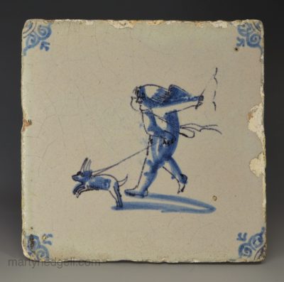 Dutch Delft tile decorated with a child walking their dog, circa 1700