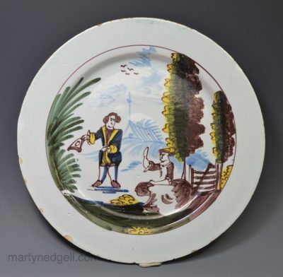 Liverpool delft plate painted with a couple in a rural setting, circa 1750