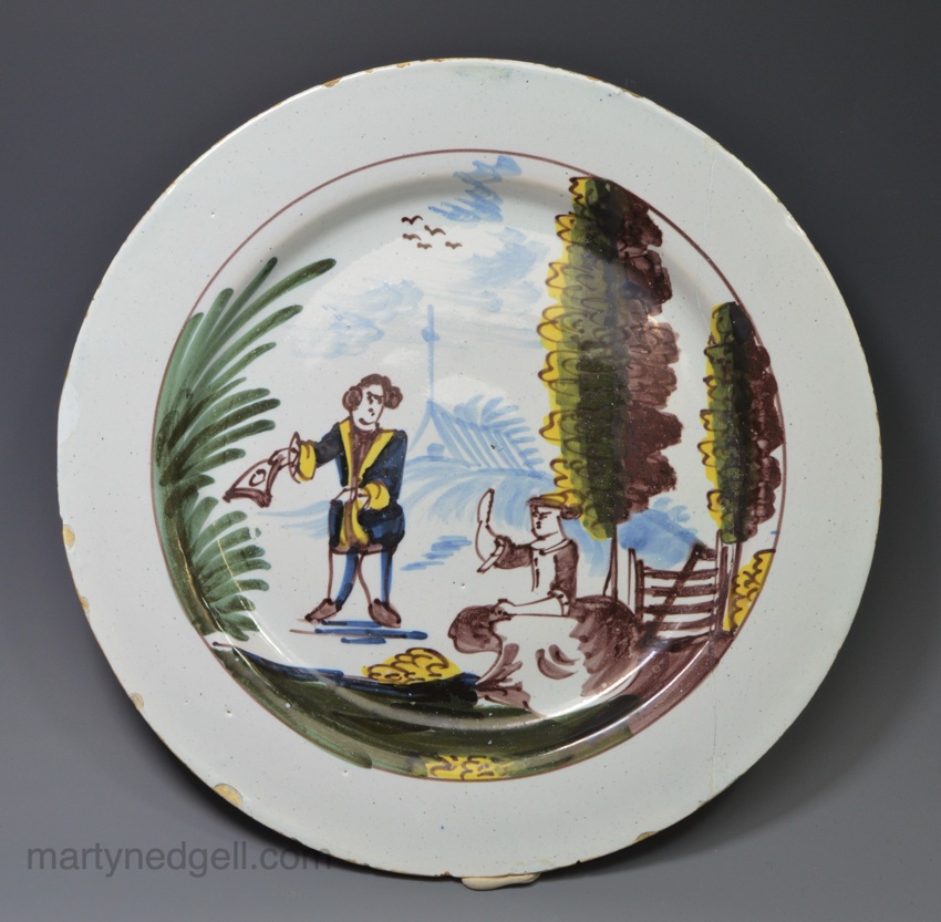 Liverpool delft plate painted with a couple in a rural setting, circa 1750