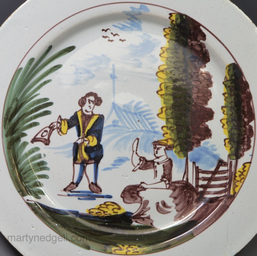 Liverpool delft plate painted with a couple in a rural setting, circa 1750